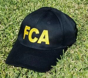 Black baseball cap with yellow FCA logo.