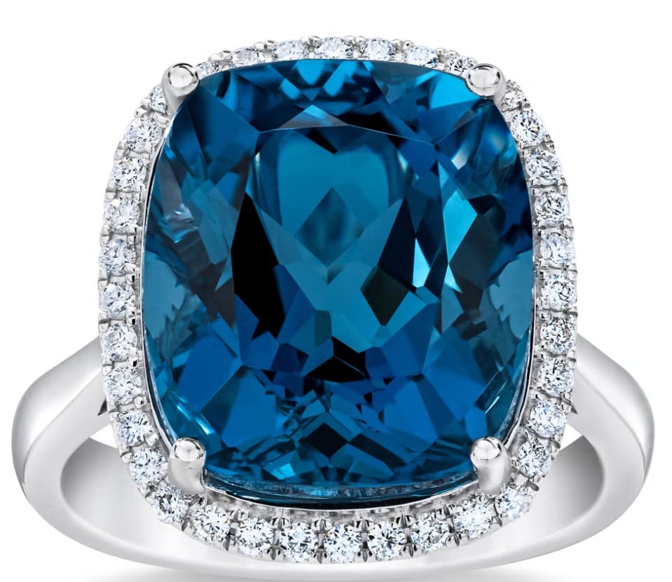 Stunning blue gemstone ring with diamond accents.
