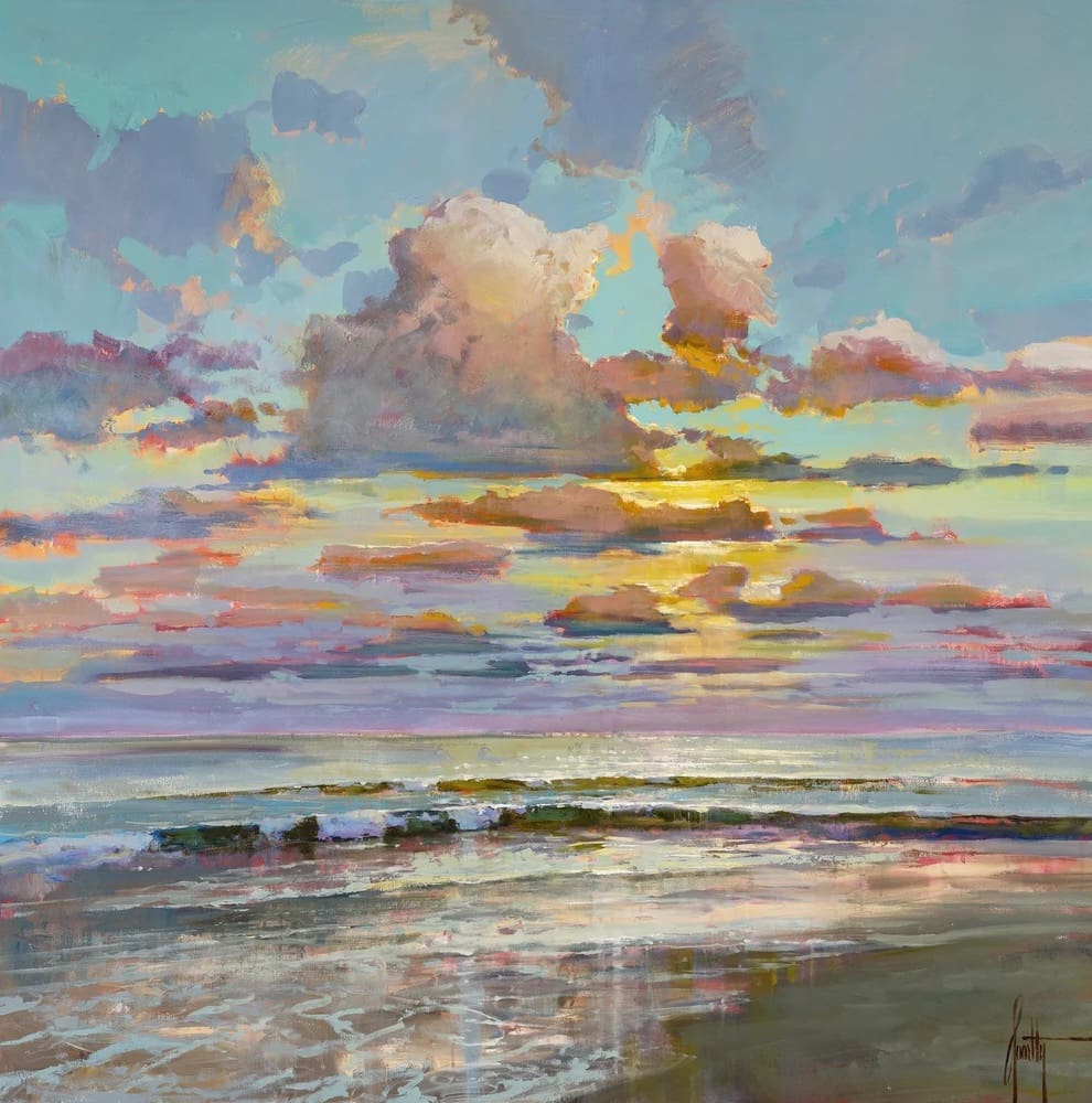 Colorful sunset over calm ocean waves.