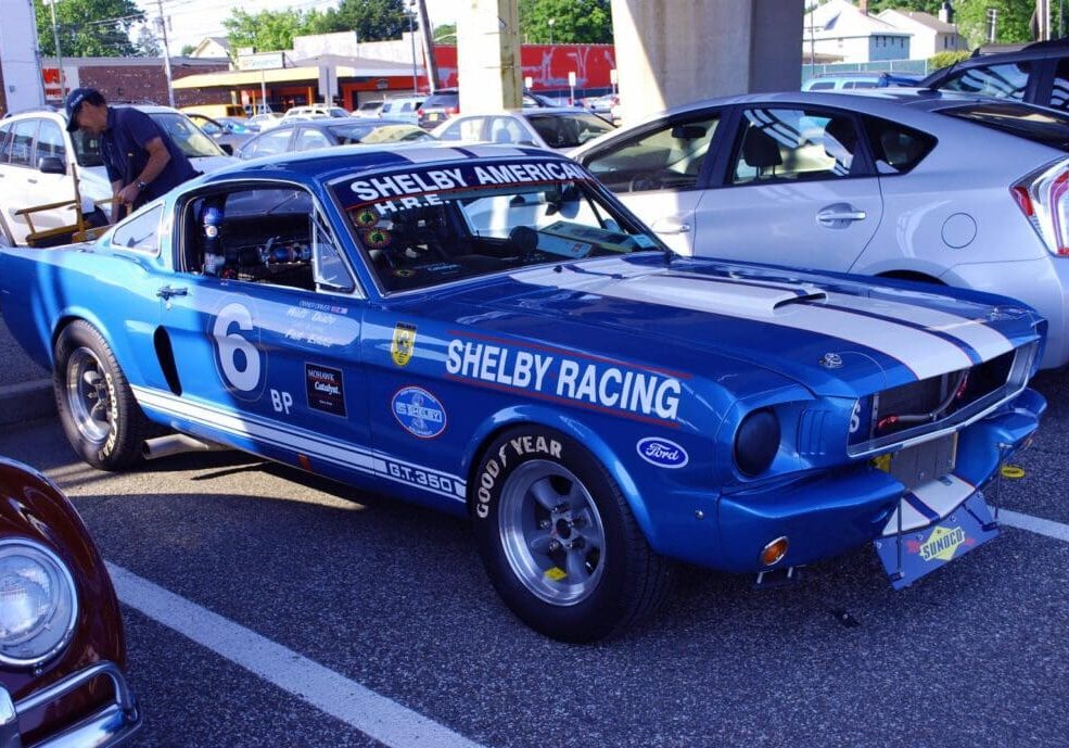 Blue Shelby Mustang with racing stripes.